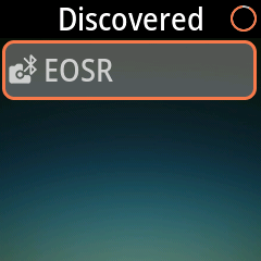 Add device page with a Canon camera listed under Discovered